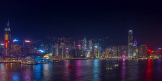 夜光飞行在香港城市市中心港湾的空中全景，4k时间间隔