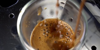 Coffee machine filling a cup with hot  coffee , slow motion