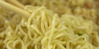 方便面和中国筷子混合在一起。酿造黄色拉面特写