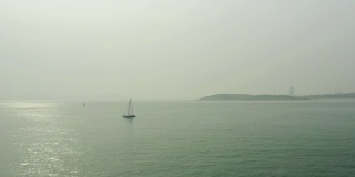 晴朗的一天青岛城市海边帆船航行航拍全景4k中国