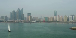 白天青岛市区海岸线海湾纪念碑帆船航行航拍全景4k中国