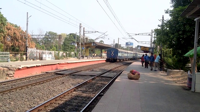 Bpl豪拉特快-13026(博帕尔交叉口至豪拉交叉口)。在郊区铁路枢纽站的铁轨上运行的印度高速火车。印度加尔各答，西孟加拉邦