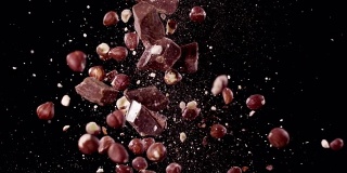 巧克力和榛子在空中碰撞超级慢动作视频1000帧/秒