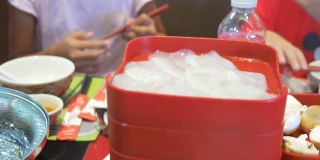 孩子们一起在餐馆吃素琪烧中国菜火锅和蔬菜。
