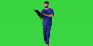 外科医生在绿色屏幕上行走时研究核磁共振脑部扫描