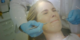 牙科医生治疗女性病人时，有发光的光点在移动