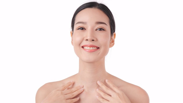 美丽的年轻亚洲女人的肖像触摸脸和健康的皮肤。