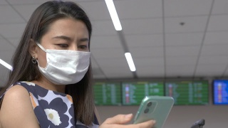 女士在机场候机楼戴口罩视频素材模板下载