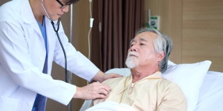 老年患者与亚洲年轻医生交谈，通过听诊器检查身体或心脏，解释疾病和治疗后在医院做什么。概念医学、保健、人。