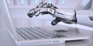 机器人用手在笔记本电脑的键盘上打字