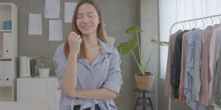 年轻迷人的亚洲女性小企业主在家庭办公室看着相机的肖像。