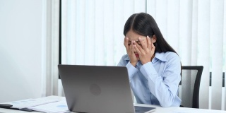 一段女商人在办公室用电脑工作时看起来很焦虑的4k视频