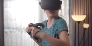 亚洲女性使用VR头盔在家玩游戏