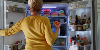在冰箱里找零食的女人