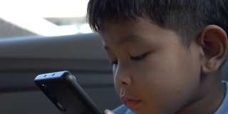 boy play phone in car