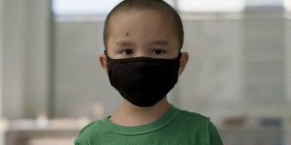 在一场全球大流行期间，戴口罩的小男孩准备返回学校。