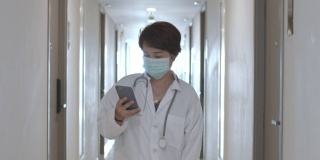 女医生戴着医用口罩用智能手机，慢镜头