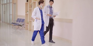 在走廊走廊医院，年轻的亚洲医生在私人病房与概念晨间病房一起散步、交谈、讨论、放松。诊所日常医疗工作。
