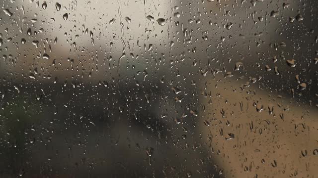雨滴落在窗玻璃表面