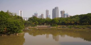 白天时间佛山城市公园池塘住宅综合体建设慢镜头全景4k中国