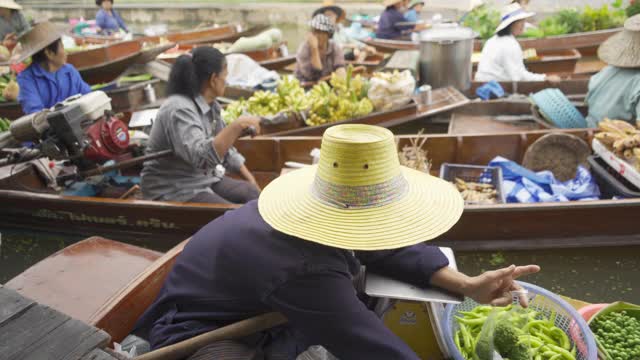 Damnoen Saduak浮动市场或安帕瓦。泰国Ratchaburi区，当地人在运河上出售水果和传统食物。亚洲著名旅游景点。