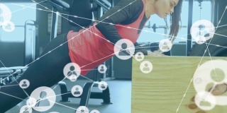 网络连接图标对着在健身房做俯卧撑的女人