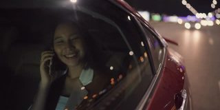 年轻的亚洲女子乘坐优步穿过城市回家