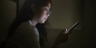 女性使用智能手机工作或在深夜上网。