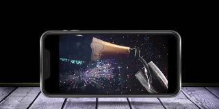 智能手机屏幕上有香槟酒瓶和玻璃杯的动画，背景中有烟花