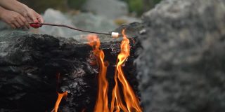 女人在独特的Yanartas山火上烤棉花糖
