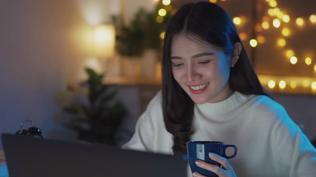 Asian teenage university student girl learning online class late night at home