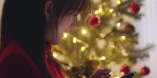 一个亚洲女孩在圣诞节用智能手机网购
