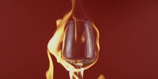 燃烧酒杯，将红酒从酒瓶倒入玻璃杯中，背景是火焰