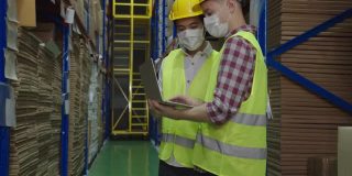 仓库工人在仓库工作时戴上防护口罩。
