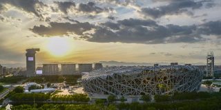 间隔拍摄。北京地标，国家体育场(鸟巢)，日落奥林匹克体育中心，中国。