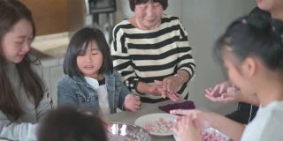 中国的老年人家庭为春节团圆饭准备中国食物“汤圆”糯米团