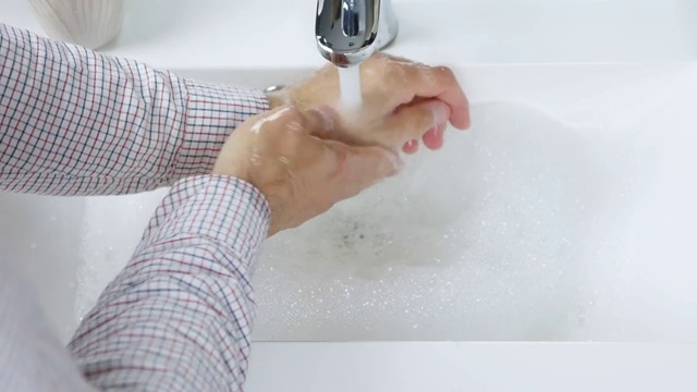 用肥皂洗手，男子彻底清洗污垢，保持身体清洁，护理双手，消毒双手防止病毒