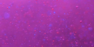 彩色的泡沫油美丽的油漆紫色的宇宙移动。空间星系的行星。星云空间恒星行星。银河系。粉色表面的宇宙在移动。蓝色假日背景圣诞节。