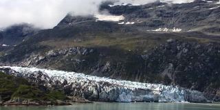 位于阿拉斯加冰川湾国家公园云雾笼罩的山脚下的冰川。