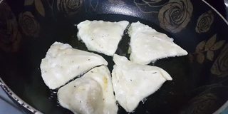 在滚烫的油锅里煎馅饼。