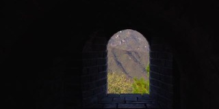 斯坦尼康镜头拍摄的中国长城，上升的一边的山。镜头穿过瞭望塔的通道，显示出长城上窗户的景色