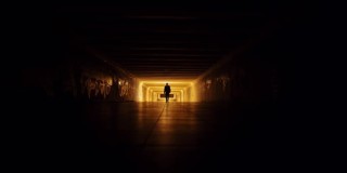 陌生男子在黑暗的地下走廊里行走的剪影。恐怖危险的街道概念