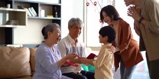 亚洲的祖父母在春节给他们的儿子和孙子红包