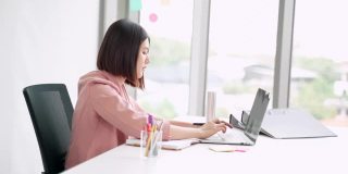 专注专注忙碌的亚洲女商人专业工作用电脑笔记本打字，写笔记，研究计划思考，创意创意策略，员工在现代办公室