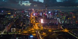 中国日落之夜照亮著名的深圳市交通路口航拍全景，4k时间的推移