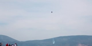 在蓝天下进行特技表演，展示F16战斗机，攀爬和射击信号弹
