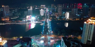 夜间照明海南岛三亚市交通街道河桥空中俯视图4k中国