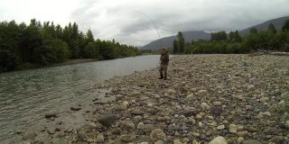 一名男子在加拿大基蒂马特河上飞钓时抓了一条鲑鱼。