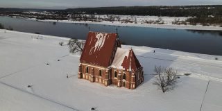 冬季航拍的独特的、真实的哥特式的施洗者圣约翰查布斯基斯老教堂位于Nemunas河岸边的山谷