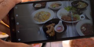 俯视图男子用智能手机拍摄餐盘上的食物